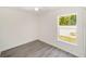 Bright bedroom featuring modern flooring and a large window with a backyard view at 15323 Sw 25Th Pl, Ocala, FL 34482