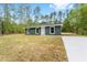 Well-kept single-story home featuring a driveway, and a welcoming facade at 15323 Sw 25Th Pl, Ocala, FL 34482