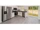 Modern kitchen with stainless appliances, granite counters, and new flooring and a view to the yard at 15323 Sw 25Th Pl, Ocala, FL 34482