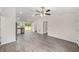 Spacious living room with wood-look floors, stainless steel appliances, and vaulted ceilings at 15323 Sw 25Th Pl, Ocala, FL 34482