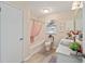 Well-lit bathroom featuring a tub/shower combo, toilet, and vanity with bright white cabinets and marble countertop at 1613 Cherry Hill Rd, The Villages, FL 32159
