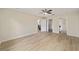 This bedroom features light, wood-look floors and access to a walk-in closet and bathroom at 1613 Cherry Hill Rd, The Villages, FL 32159