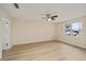 This bedroom features a ceiling fan, neutral paint and light wood-look flooring at 1613 Cherry Hill Rd, The Villages, FL 32159