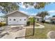 This house has great curb appeal with a well manicured lawn, palm tree, and two car garage at 1613 Cherry Hill Rd, The Villages, FL 32159