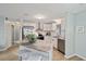 A modern kitchen with stainless steel appliances, granite countertops, and an island with bar stool seating at 1613 Cherry Hill Rd, The Villages, FL 32159