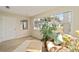 Bright living room with natural decor, big window with views of the outside, and wooden-look flooring at 1613 Cherry Hill Rd, The Villages, FL 32159
