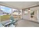 Enclosed patio with neutral walls, chairs, and views of the grassy backyard at 1613 Cherry Hill Rd, The Villages, FL 32159