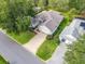Aerial view of the home showing the roof, driveway, and professionally landscaped yard at 16814 Se 80Th Bellavista Cir, The Villages, FL 32162