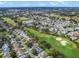 A scenic aerial shot of a residential community featuring a golf course and mature landscaping at 16814 Se 80Th Bellavista Cir, The Villages, FL 32162