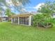 Nice exterior view of the house with a screened lanai and tropical landscaping at 16814 Se 80Th Bellavista Cir, The Villages, FL 32162