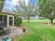 View of the beautiful backyard and well-maintained landscaping adjacent to the golf course at 16814 Se 80Th Bellavista Cir, The Villages, FL 32162