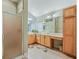 Bathroom featuring double sinks, a walk-in shower, and ample counter space at 16814 Se 80Th Bellavista Cir, The Villages, FL 32162