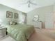 Calm bedroom featuring a plush bed, dresser, and soothing color palette at 16814 Se 80Th Bellavista Cir, The Villages, FL 32162
