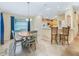 Inviting eat-in kitchen with breakfast bar, tile floors and a window overlooking the backyard at 16814 Se 80Th Bellavista Cir, The Villages, FL 32162