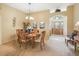Well-appointed dining room featuring a chandelier, a plant, neutral tones, and archway to entry at 16814 Se 80Th Bellavista Cir, The Villages, FL 32162