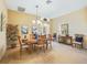 Formal dining room featuring a chandelier, elegant furnishings, and soft natural light at 16814 Se 80Th Bellavista Cir, The Villages, FL 32162