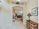 Inviting foyer with tile flooring, an archway leading to the living room, and a charming side table at 16814 Se 80Th Bellavista Cir, The Villages, FL 32162