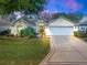 Charming single-story home featuring a well-manicured lawn and a two-car garage at 16814 Se 80Th Bellavista Cir, The Villages, FL 32162