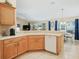 Spacious kitchen featuring wood cabinets, white countertops and access to the dining area and living room at 16814 Se 80Th Bellavista Cir, The Villages, FL 32162