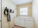 Laundry room with cabinets, a countertop, a hanging rack, and tile flooring at 16814 Se 80Th Bellavista Cir, The Villages, FL 32162