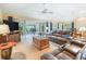 Bright living room featuring a leather sectional sofa, patio access, and lots of space at 16814 Se 80Th Bellavista Cir, The Villages, FL 32162