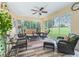Bright sunroom with comfortable seating, tile flooring, and a view of the golf course at 16814 Se 80Th Bellavista Cir, The Villages, FL 32162