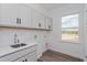 Laundry room with gray cabinets, quartz countertop and window at 17006 Clear Mind Aly, Winter Garden, FL 34787