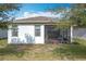 Rear view of house showcasing screened porch and landscaping at 17313 Blazing Star Cir, Clermont, FL 34714