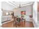 Dining room with wood flooring, a chandelier, and a view into the living room and kitchen at 177 Boardman Dr, Umatilla, FL 32784