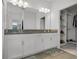 Double vanity bathroom with granite countertops and walk-in closet at 17938 Hither Hills Cir, Winter Garden, FL 34787