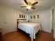 Bright bedroom with double bed, ceiling fan, and ample closet space at 1802 Petunia Ln, The Villages, FL 32159