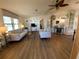 Open living space with kitchen and wood-look floors at 1802 Petunia Ln, The Villages, FL 32159