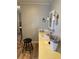 Bathroom featuring a sink, mirror, stool, and a yellow countertop at 188 Hibiscus Way, Leesburg, FL 34748