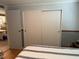 Bedroom features a closet and a glimpse of the living area at 188 Hibiscus Way, Leesburg, FL 34748