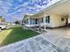 Well-manicured lawn and landscaping enhance the appeal of this home's exterior featuring a comfortable sunroom at 188 Hibiscus Way, Leesburg, FL 34748