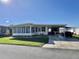 Inviting single-story home featuring a carport and well-manicured lawn at 188 Hibiscus Way, Leesburg, FL 34748