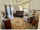 Comfortable living room with neutral color scheme and sliding glass doors at 188 Hibiscus Way, Leesburg, FL 34748
