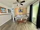 Cozy living room featuring wood paneling and neutral-toned flooring at 188 Hibiscus Way, Leesburg, FL 34748