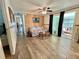 Bright living room with wood flooring and sliding glass doors to porch at 188 Hibiscus Way, Leesburg, FL 34748