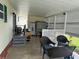 Comfortable enclosed patio featuring ample seating and space for relaxation with outdoor lighting at 188 Hibiscus Way, Leesburg, FL 34748