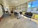 Enclosed patio featuring ample seating and space for relaxation or entertainment, with view of neighborhood at 188 Hibiscus Way, Leesburg, FL 34748