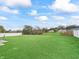 Large grassy backyard enclosed by a white privacy fence and chain link fence at 21 Bahia Pass Loop, Ocala, FL 34472