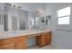 Bathroom with double sink vanity, large mirror, and good natural light at 2507 Caribe Dr, The Villages, FL 32162