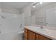 Bathroom with a shower-tub combination, a white sink with a wooden cabinet, and neutral-colored walls at 2507 Caribe Dr, The Villages, FL 32162