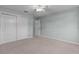 Bedroom features carpet, double closet, ceiling fan, and a light blue wall, offering a comfortable retreat at 2507 Caribe Dr, The Villages, FL 32162