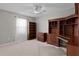 Comfortable bedroom with carpet, ceiling fan, and built in shelving at 2507 Caribe Dr, The Villages, FL 32162