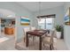 Cozy dining room with wood table, seating for four, and stylish chandelier at 2507 Caribe Dr, The Villages, FL 32162