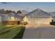 Two-car garage with a well-lit front yard at 2507 Caribe Dr, The Villages, FL 32162