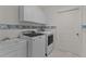 Bright laundry room features modern washer, dryer, sink, and ample storage above at 2507 Caribe Dr, The Villages, FL 32162