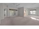 Bright living room with neutral carpet, sliding doors to the lanai, and ample natural light at 2507 Caribe Dr, The Villages, FL 32162